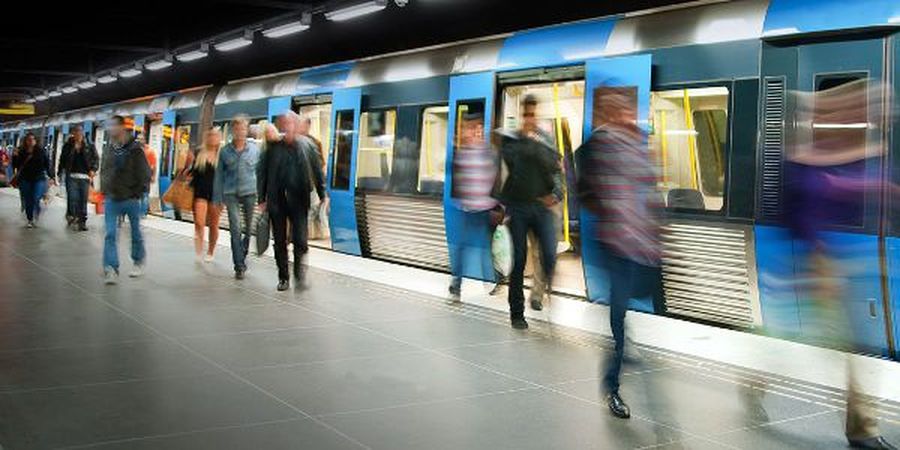 Blurred people on subway platform leaving the train